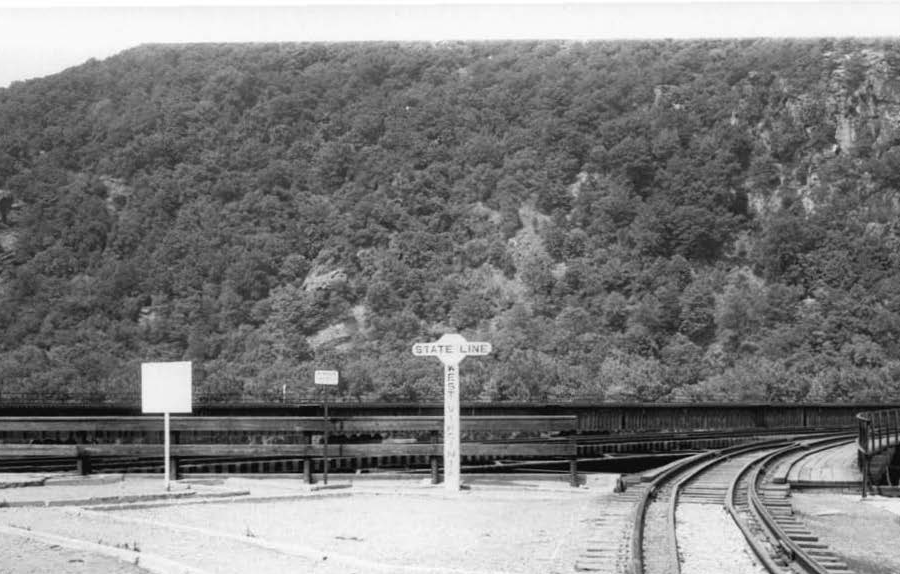 the Baltimore and Ohio (B&O) railroad bridge constructed in 1894 at Harpers Ferry had a sign showing the state boundary was on the southern edge of the Potomac River, not in the middle