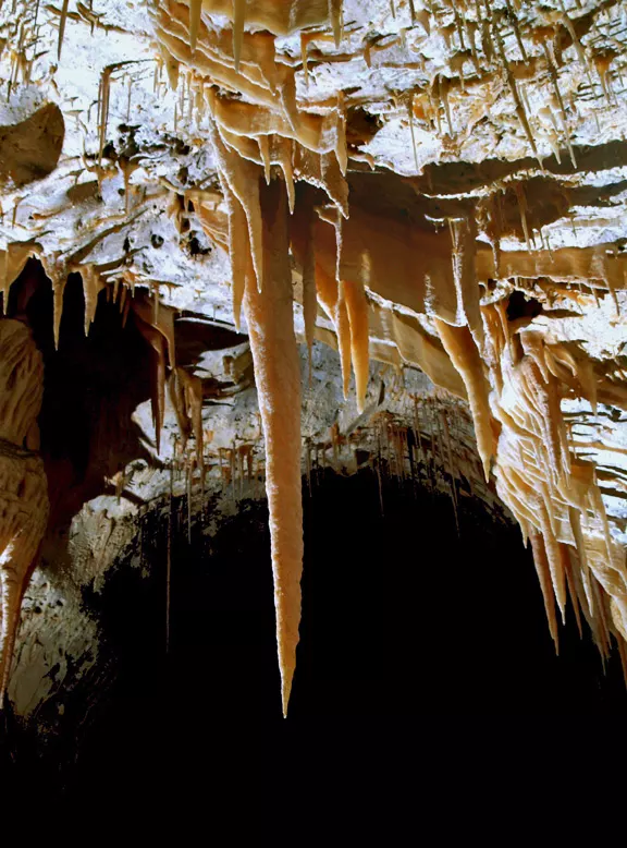 when hollow soda straws get clogged, water flows on the outside of the tube and a stalactite develops