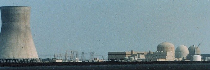 large nuclear power plants have cooling towers (on left) and containment buildings for reactors (on right)