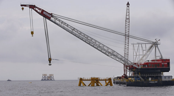 offshore wind turbines require construction of towers that rest on the bottom of the ocean