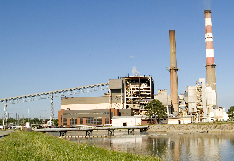 Yorktown Power Station, with coal conveyor on left, air quality control equipment to manage fly ash/flue gases next to stack, and cooling canal in foreground