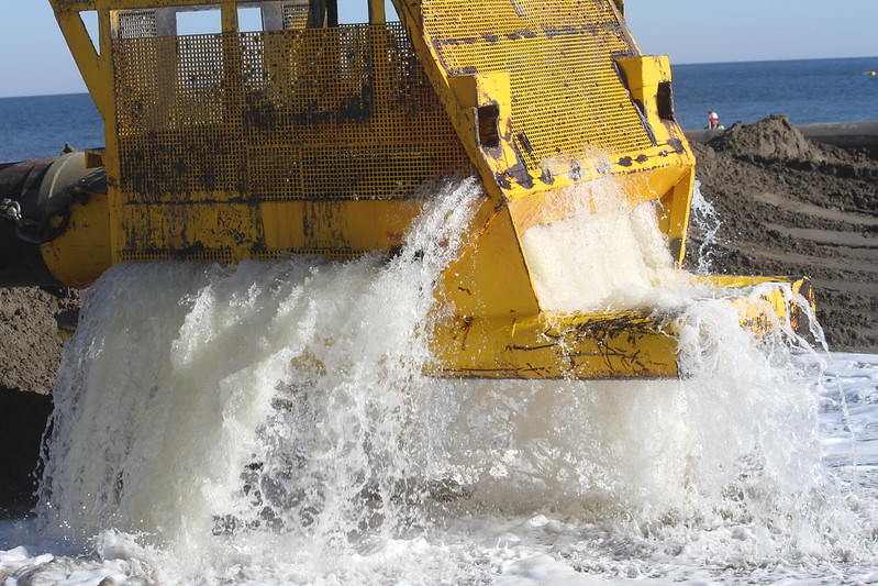 sand and water arrive via the pipe at the beach