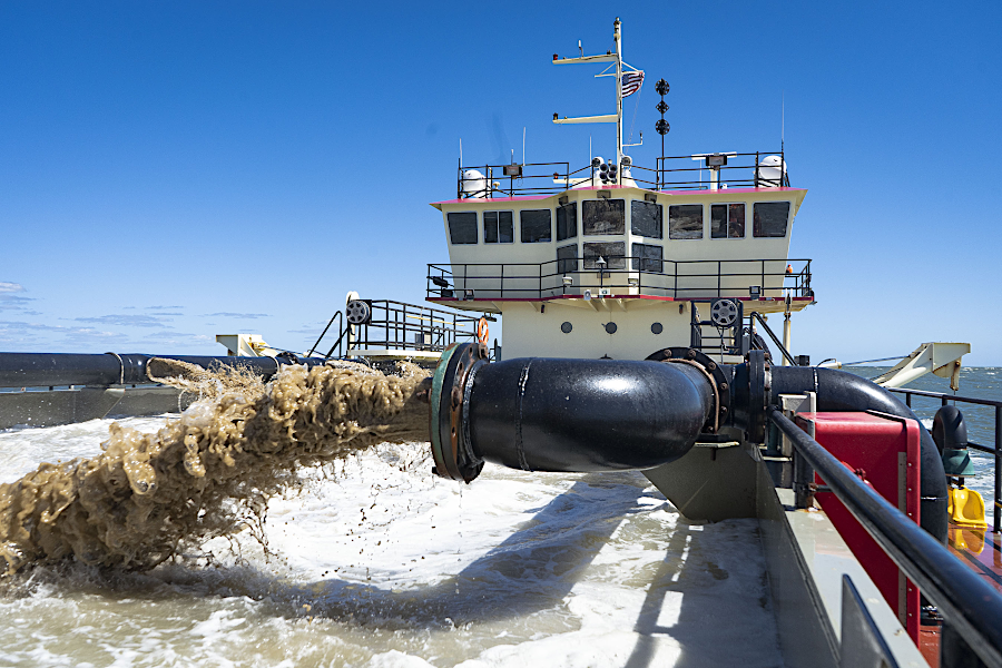 sand can be dredged from shipping channels into barges and then transported to replenish a beach