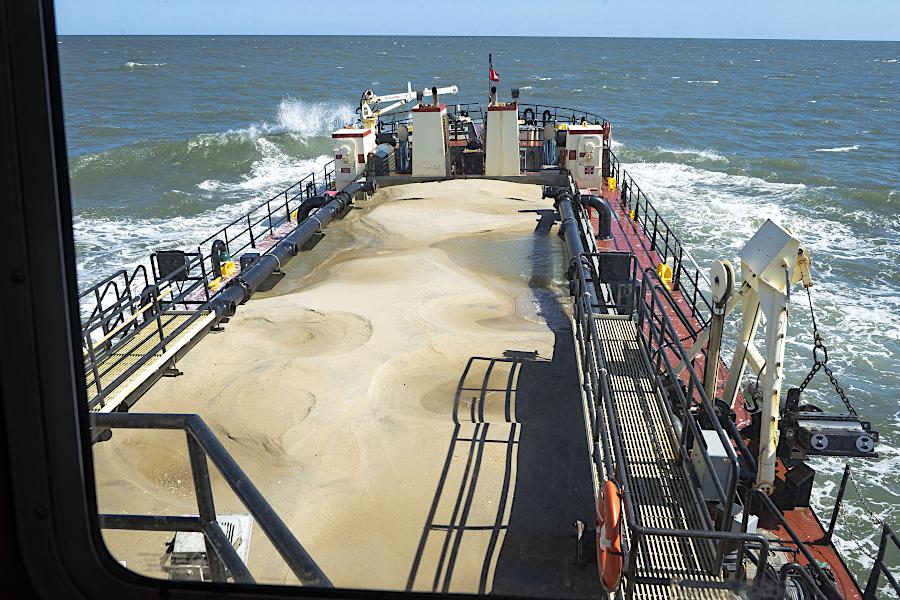 sand can be dredged from shipping channels into barges and then transported to replenish a beach