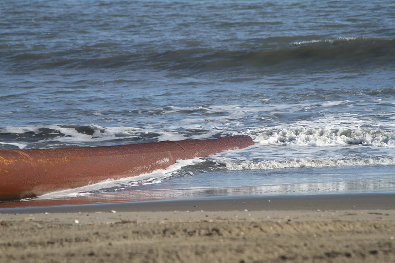 sand was pumped from the hopper dredge though pipes to the resort area beach