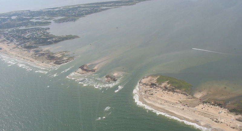 storm surges can create new inlets, carving one or more channels (breaches) completely through a barrier island