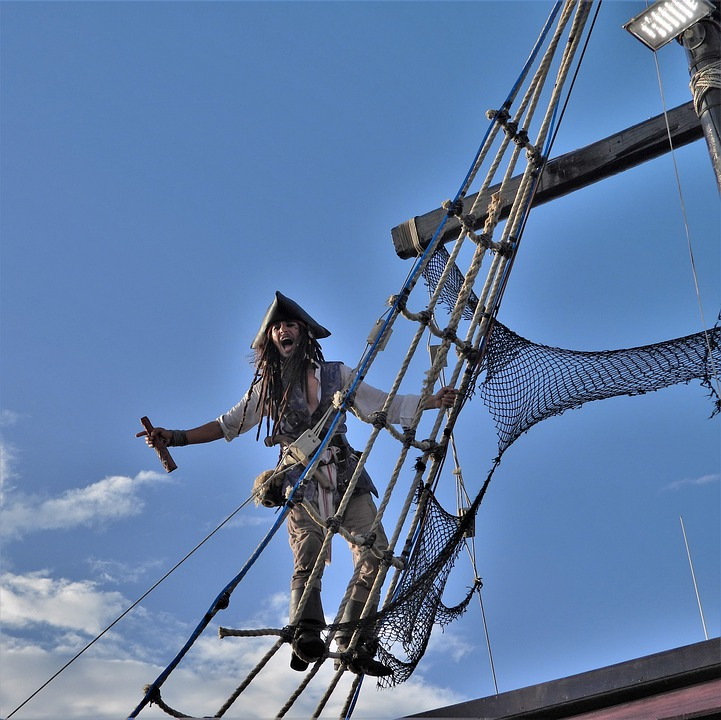 courageous man hanging on a steel wire Stock Photo