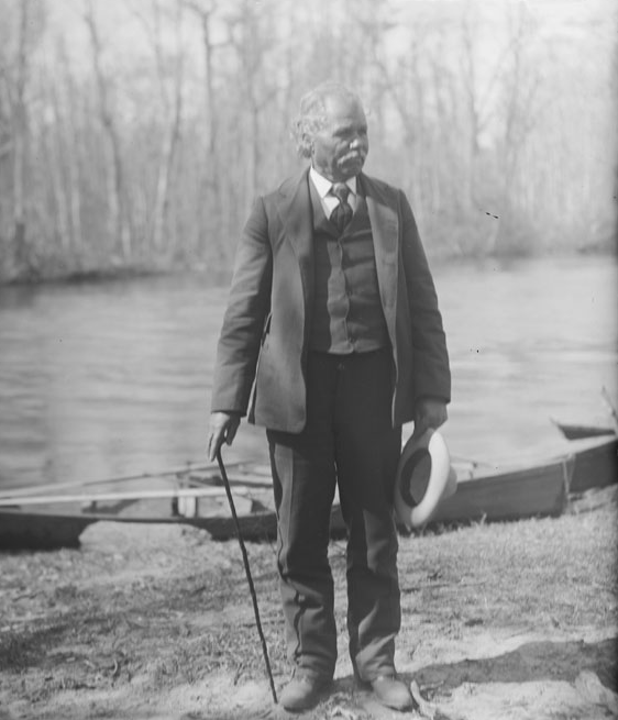 Chickahominy man with boats in background