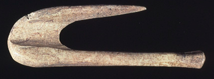 Native Americans make fishhooks by carving bone