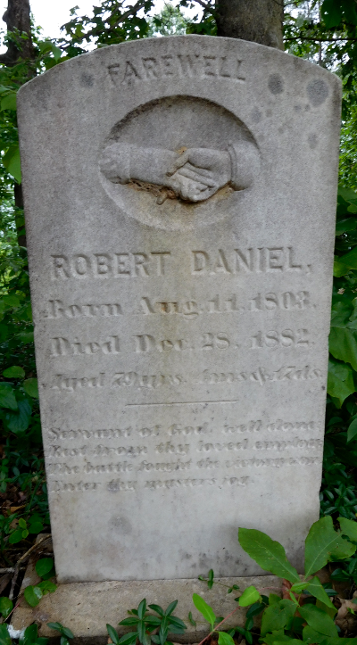 periwinkle grows at the base of a gravestone at Forks of Willis Church