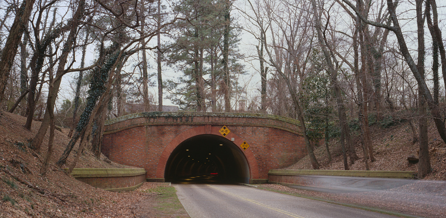 vehicles pass underneath Historic Williamsburg through a tunnel on the Colonial Parkway