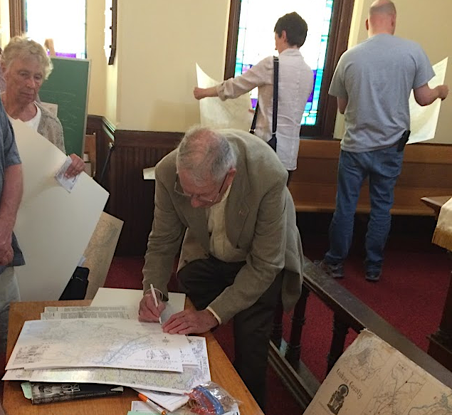 Loudoun County cartographer and historian Gene Scheel, signing map he produced showing places related to Native Americans in Loudoun County