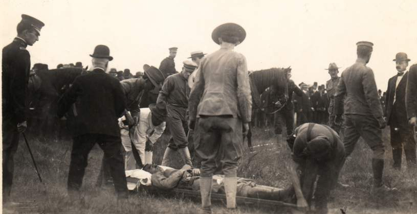soldiers and civilians gather around Lt. Thomas Selfridge (on stretcher) after he was fatally injured in the crash of the Wright (Co) Type A Military biplane