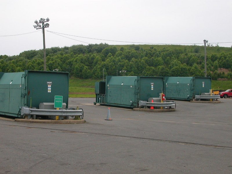 waste collection at I-66 transfer station in Fairfax County (with closed landfill in background)