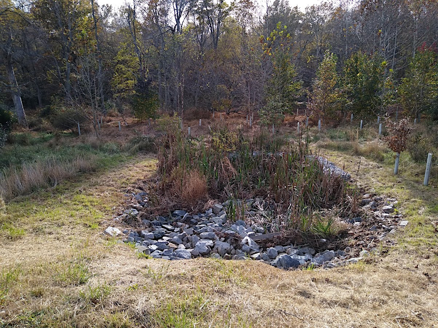 stormwater ponds release runoff through channels that use stone to diffuse the energy of the flow